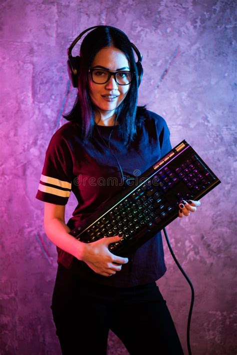 Beautiful Friendly Pro Gamer Streamer Girl Posing With A Keyboard In Her Hands Wearing Glasses