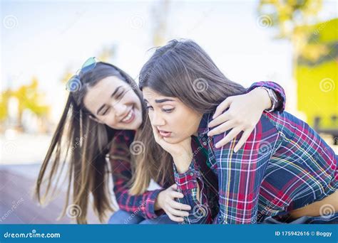 Young Woman Comforts A Sad Female Friend Stock Photo Image Of