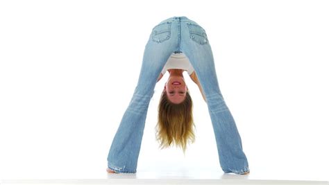 Back View Of Young Woman In Tight Jeans Bending Over And Smiling