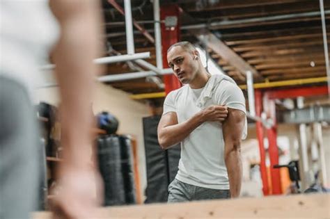Muscular Ethnic Sportsman Pushing Up On Dumbbells In Gym · Free Stock Photo