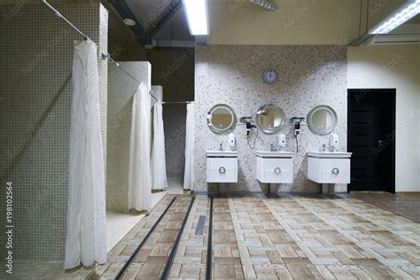 Public Shower Interior With Everal Showers Toilet Sink And Lockers In