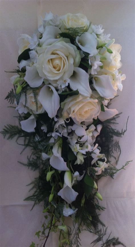 natural shower bouquet of roses calla lilies dendrobium orchids and narcissi with asparagus