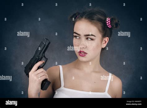 Serious Girl With Gun On Black Background Stock Photo Alamy