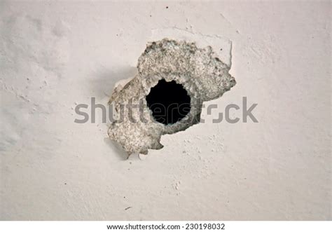 Bullet Hole On White Wall Stock Photo Edit Now 230198032