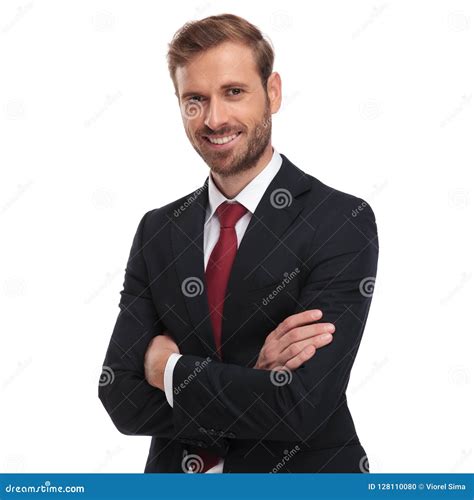 Portrait Of Smiling Businessman Standing With Hands Folded Stock Photo