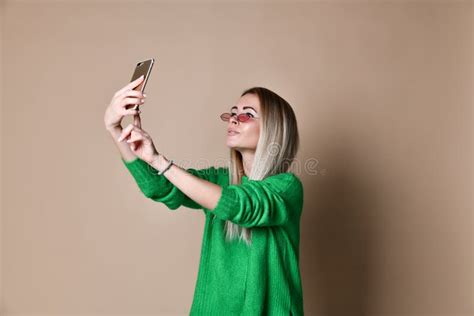 Close Up Portrait Of Young Cheerful Fashion Blonde Woman In Sweater Wear Makes Selfie On