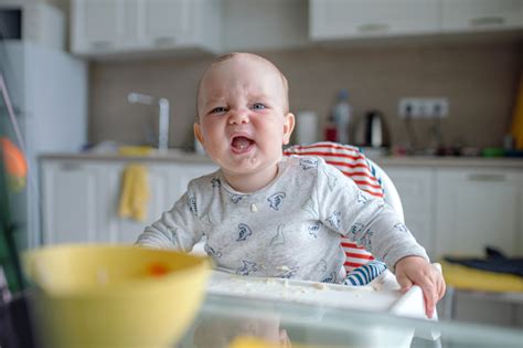 Sulking Baby Boy At The Dinner Table Stock Photo Download Image Now