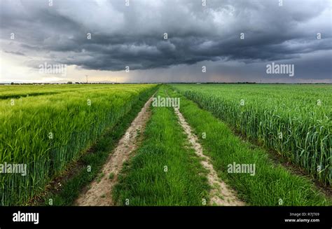 Storm Clouds Over Field And Road Stock Photo Alamy