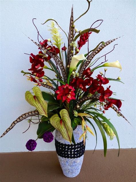 Welcome to the official facebook page of arcadia! Tropical arrangement in black and grey vase. Designed by ...