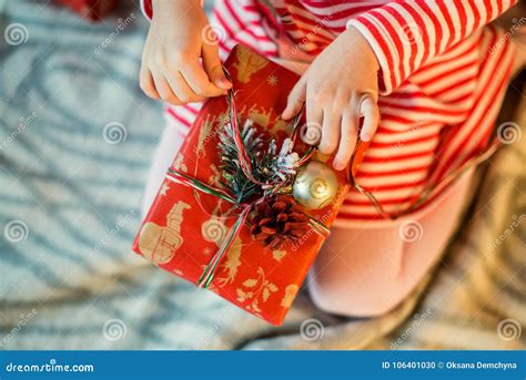Little Girl Unpacks A Decorated Christmas T Box Close Up Stock