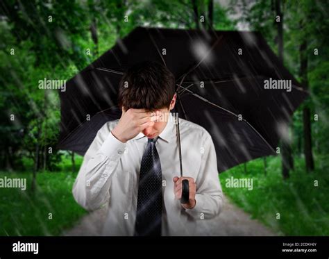 Sad Man Under Rain Stock Photo Alamy