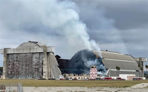 Firefighters Battle Blaze At Historic Former Marine Corps Hangar In