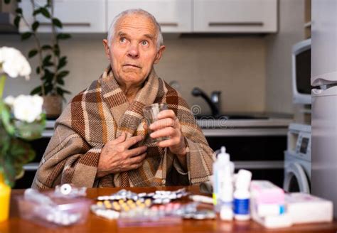 old man with many medical pills and capsules in hands stock image image of alone caucasian