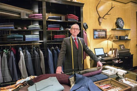 Senior tailor in tailors shop, portrait - Stock Photo - Dissolve
