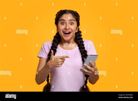 Excited Indian Woman Using Mobile Phone Celebrating Online Win Stock