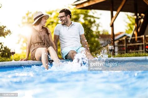 Young Couple Splashing And Playing In The Pool Photos And Premium High Res Pictures Getty Images