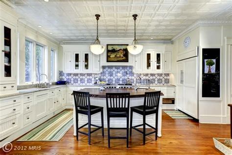 It's a great backdrop to the open shelving, and the color of the cabinets echoes the perfect. Washington, DC | Wood floor kitchen, Tin ceiling kitchen ...