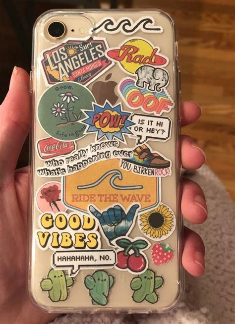 Someone Is Holding Up Their Phone Case With Stickers On It