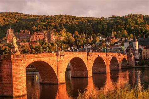 Panoramic View During Red Sunset At Old Bridge Downtown And Castle In