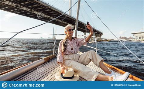 Happy Mature Woman On Yacht Trip Taking A Selfie Stock Image Image Of