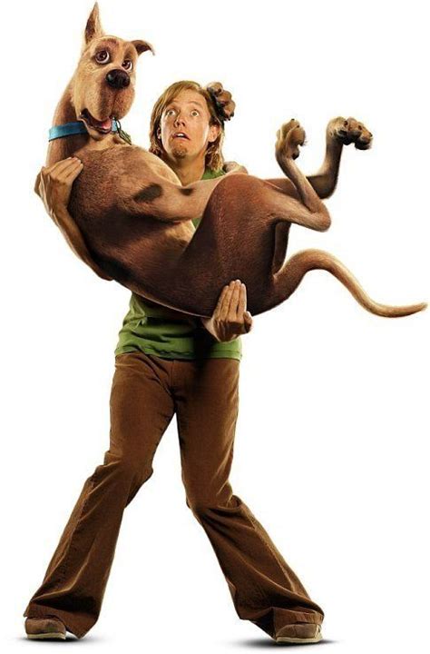 A Man Holding A Dog In The Shape Of A Cat On His Back While Standing