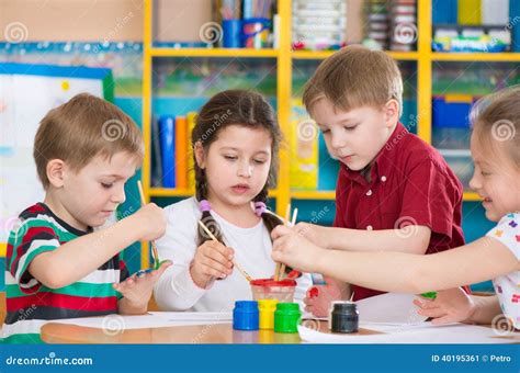 Cute Children Drawing With Colorful Paints At Kindergarten Stock Image