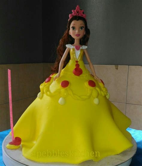 This cake is frosted with smooth yellow buttercream, decorated with floral style piping and sprinkles and toy topper. Princess Belle inspired doll cake | Doll cake, Super moist ...