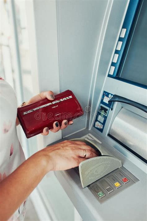 Woman Withdrawing Money From Atm Machine Using Debit Or Credit Card