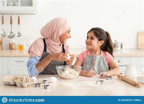 Leisure With Mom Happy Muslim Mother And Little Daughter Baking In
