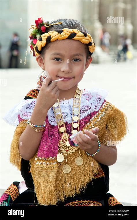 Small Indigenous Mexican Girl With Lollipop In Traditional Costume On