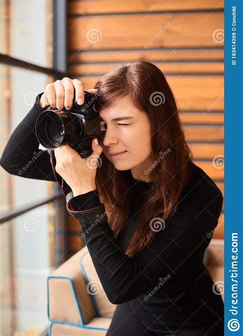 Woman Photographer With Camera Taking Photo On Professional Photo Shoot