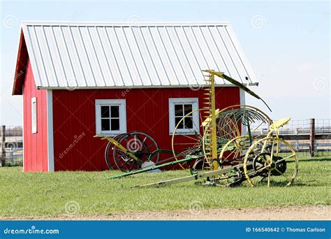 Vintage Farm Equipment In Front Of Red Building Stock Photo Image Of