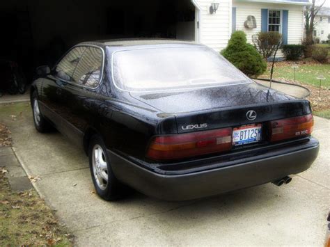 The vehicle is green with a tan interior. AutoSleek: "White Smoke Comes Out from 1994 Lexus ES300 Exhaust"