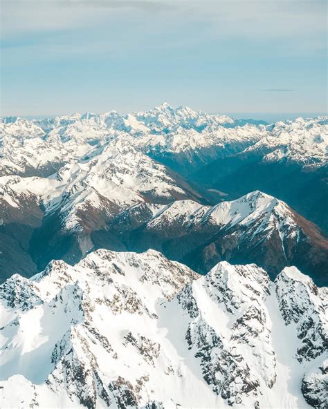 The Snow Capped Mountain Ranges On The South Island New Zealand From