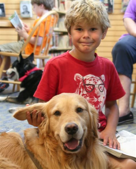 Danny Gonzalez pets Harper’s ear while reading a story during Mentor
