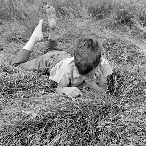 1950s Barefoot Boy Lying Stomach Down Photograph By Vintage Images