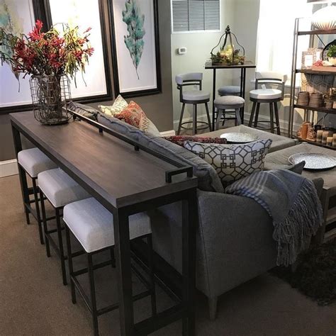 Perfect as a compact dining/console table behind a sofa, this console table seats up to three at counter height. Console table and stools behind couch | Sofa table decor ...