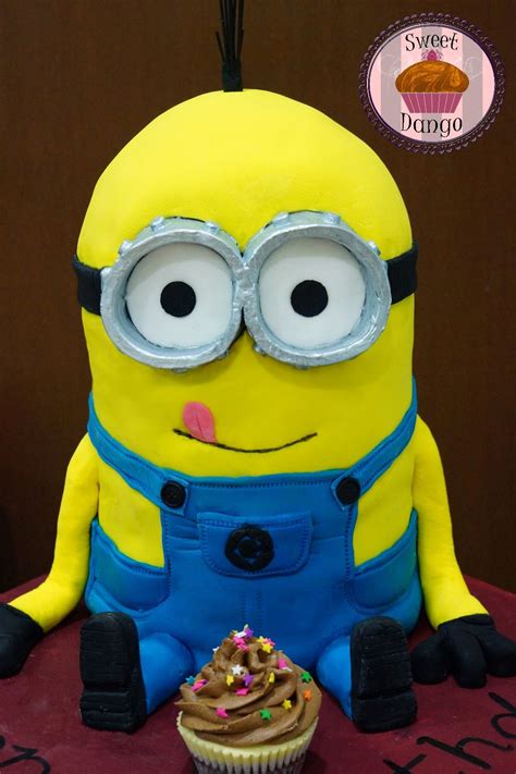 Another spectacular cake design from hot mama's cakes features a slight variation with a minion shaped cake wearing. Kevin the Minion cake enjoying a little cupcake! | Minion cake