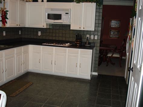 A stone or ceramic tile floor in the kitchen is durable and adds visual drama. Dark Green Kitchen Floor Tiles | Dark green kitchen ...