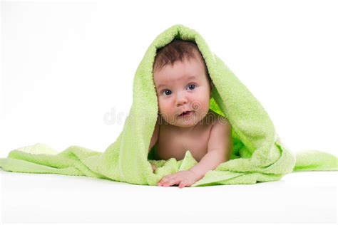 Newborn Baby Lying Down And Smiling In A Green Towel Stock Photo