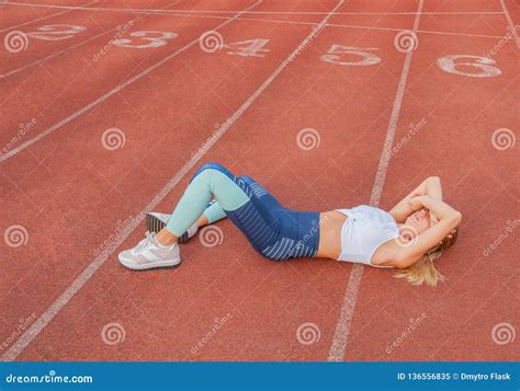 Tired Woman Runner Taking A Rest After Run Lying On The Running Stock