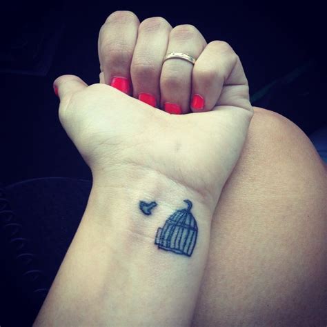 28 adorable fearless wrist tattoos; 27 Dazzling Bird Cage Wrist Tattoos
