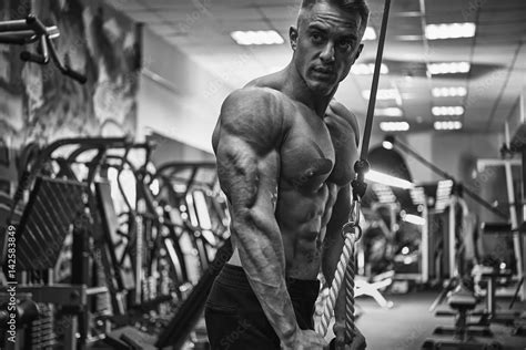 Black And White Portrait Of Confident Bodybuilder Workout Triceps