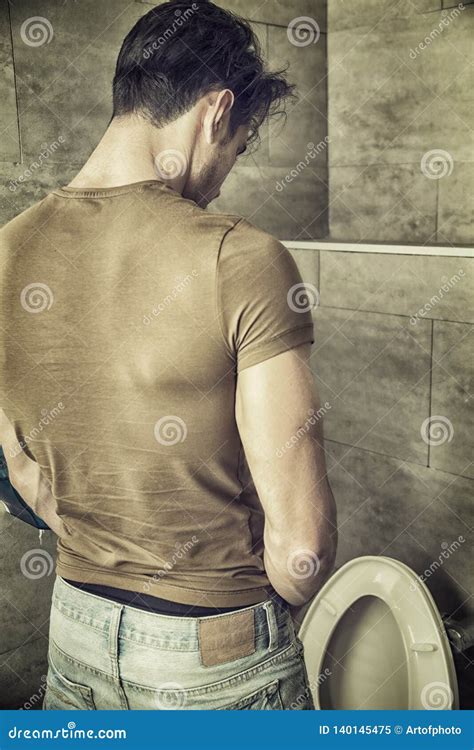man peeing in toilet at home royalty free stock image 69316924