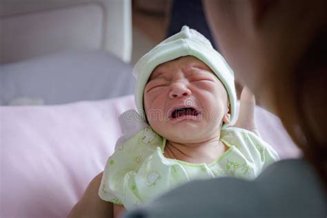 Newborn Baby Boy Crying Over The Shoulder Of His Father Stock Image