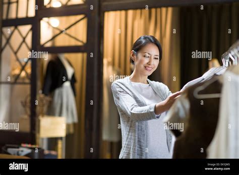 Clothing Store Owner Checking Clothes Stock Photo Alamy