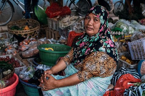 Indonesian Old Woman Selling Fruits And Vegetables In Local Market By