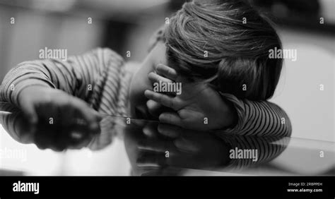 Depressed Child Covering Face Trauma Concept In Monochrome Stock Photo