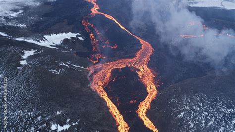 Lava Eruption Volcano With Snowy Mountains Aerial View Hot Lava And