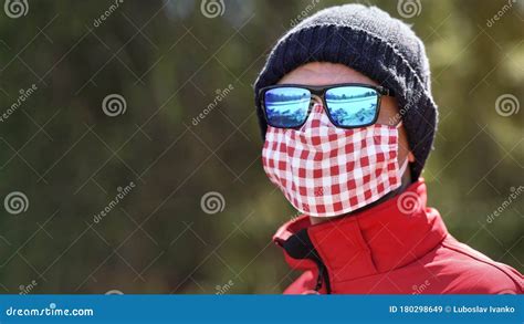 Man Wearing Beanie Hat Blue Shiny Sunglasses And White Red Cotton Home